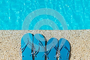 Flip Flop on stone Floor pool edge with surface of water background