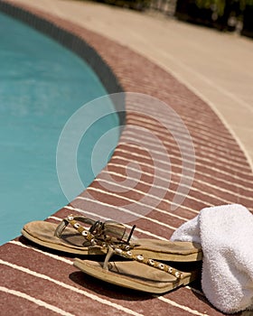 Flip-Flop and a towel by a pool