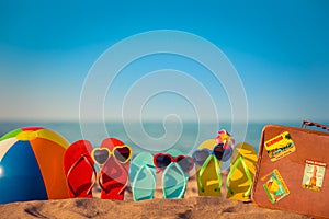 Flip-flops, beach ball and suitcase