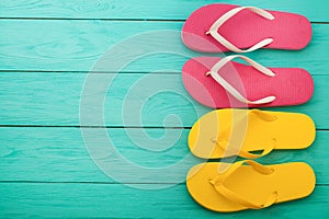 Flip flops on blue wooden background with copy space. Beach accessories. Top view. Mock up. Summer shoes sandals. Slippers