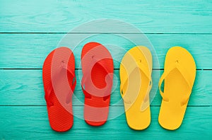 Flip flops on blue wooden background with copy space. Top view. Mock up. Summer shoes sandals. Slippers