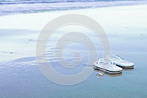 Flip-flops in the coastal water at low tide