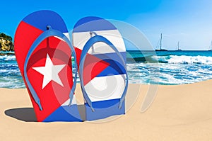 Flip flops with Cuban flag on the beach. Cuba resorts, vacation, tours, travel packages concept. 3D rendering