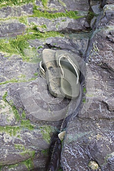 Flip flops discarded on a beach rock