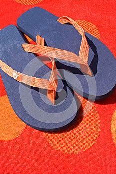 Flip flops on orange towel