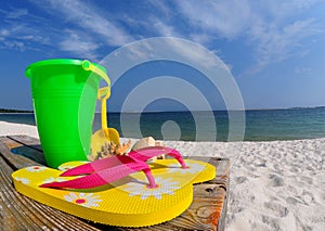 Flip flops and pail on boardwalk