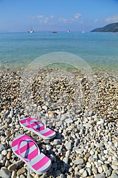 Flip flops on pebbled beach