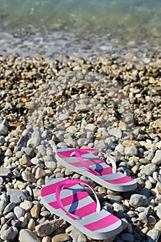 Flip flops on pebbled beach closeup