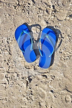 Flip-flops on the sand.