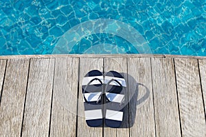 Flip flops  at the side of swimming pool, summer travel concept