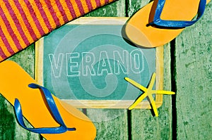 Flip-flops, starfish and chalkboard with the word verano, summer photo