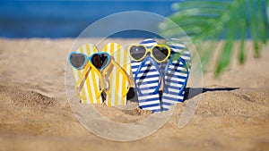 Flip-flops and sunglasses on the sand. Summer vacation concept