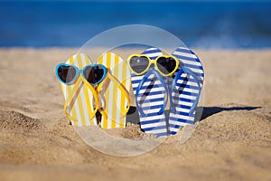 Flip-flops and sunglasses on the sand. Summer vacation concept