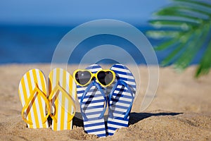 Flip-flops and sunglasses on the sand. Summer vacation concept