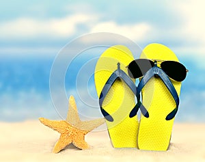 Flip-flops and sunglasses with starfish on beach