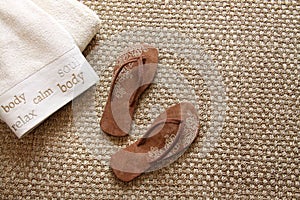 Flip flops with towels on seagrass rug photo