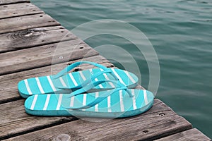 Flip flops at the wooden pier at lake