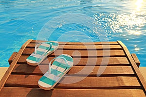 Flip flops on wooden sunbed