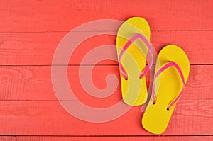 Flip Flops Yellow on red wooden background