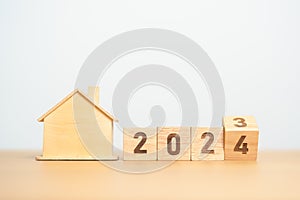 flip 2023 to 2024 block with house model. real estate, Home loan, tax, investment, financial, savings and New Year Resolution