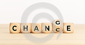 Flip wooden cube with word change to chance