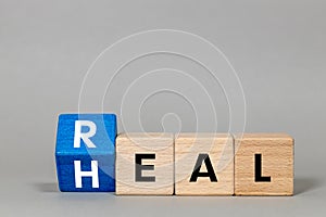 Fliped a wooden cube with words \'Real heal\'. Medical and real heal concept. Real heal symbol. copy space