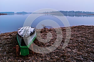 Flipped boat at lake shore