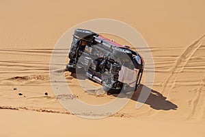 Flipped car on sand