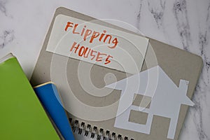 Flipping House text on sticky notes isolated on office desk