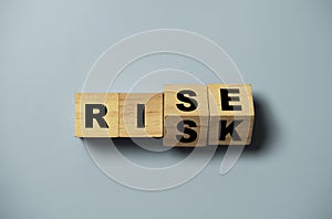 Flipping of wooden cube block between rise and risk for risk analysis assessment and management concept