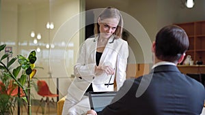 Flirt and romance in the office. Office flirting - attractive woman flirting with her colleague. Woman flirting with