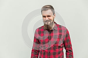 Flirt and wink. Carefree bearded man winked at camera and smiling