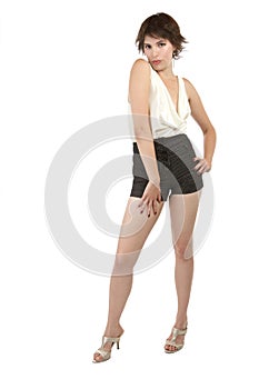 Flirtatious young woman stands with hand on hip