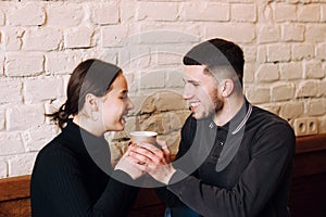 Flirting in a cafe. Beautiful loving couple sitting in cafe enjoying in coffe and conversation