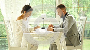 Flirting in a cafe. Beautiful loving couple sitting in a cafe enjoying in coffee and conversation