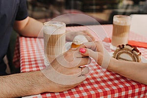 Flirting in a cafe. Beautiful loving couple sitting in a cafe enjoying in coffee and conversation. Love and romance. Blurred and