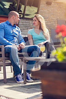 Flirting in a cafe. Beautiful loving couple sitting in a cafe enjoying in coffee and conversation. Love, romance, dating