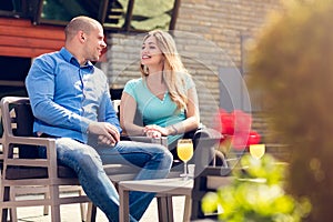 Flirting in a cafe. Beautiful loving couple sitting in a cafe enjoying in coffee and conversation. Love, romance, dating