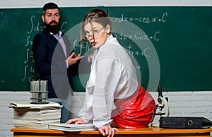 Flirting with colleague. Everyone dreaming about such teacher. Attractive teacher in leather skirt. Cheeky teacher