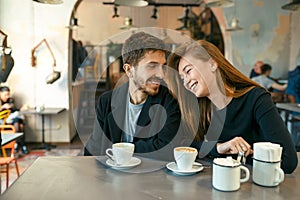 Flirting young couple in cafe