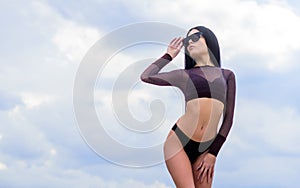 Flirty beauty. Girl attractive sexy body posing sky background. Booty woman wear bikini. Sporty girl sexy body. Resort