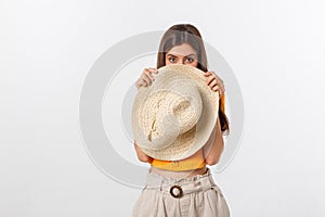 Flirty funky caucasian woman hiding behind fashionable trendy red head wear, with wide open eyes