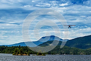 Float plane flying above Ruby Lake, Sunshine Coast, BC, Canada