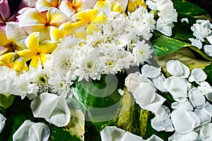 Floating assorted flowers in a big water jar.