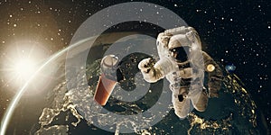 Floating astronaut and coffee mug at sunrise. Coffee break and breakfast concept. 3D and photo compositing, elements from NASA photo
