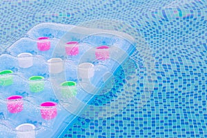 Floating blue and pink air mattress in pool