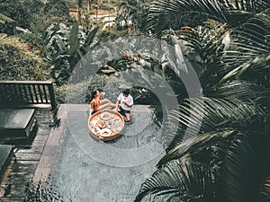 Floating breakfast in infinity pool on paradise swimming pool, morning in the tropical resort Bali, Indonesia