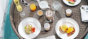 Floating Breakfast tray in swimming pool at luxury hotel or tropical resort villa, fruits; mango, watermelon dragon and passion