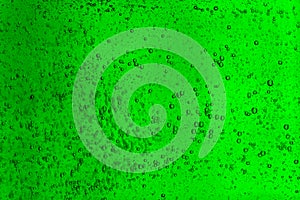 Floating bubbles in green liquid background texture.