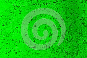 Floating bubbles in green liquid background texture.